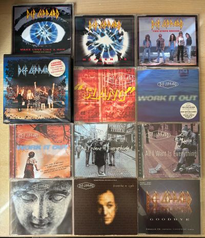 Collection of Def Leppard CDs and singles.
