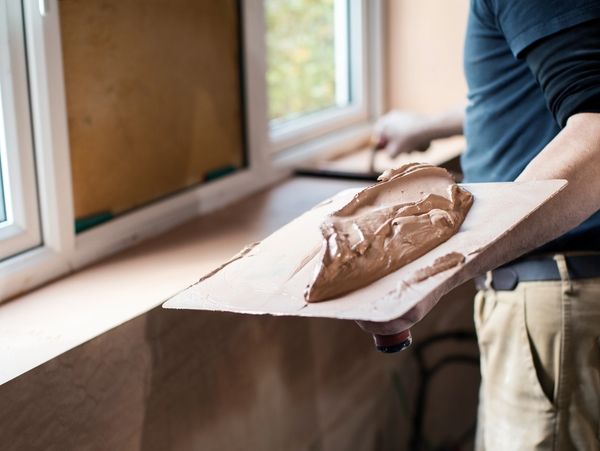 A professional applying plaster on walls