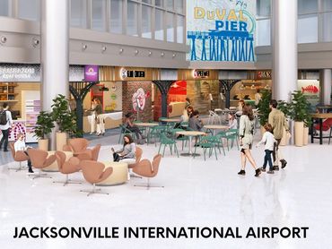 Modern seating area inside Jacksonville International Airport with people walking and sitting.