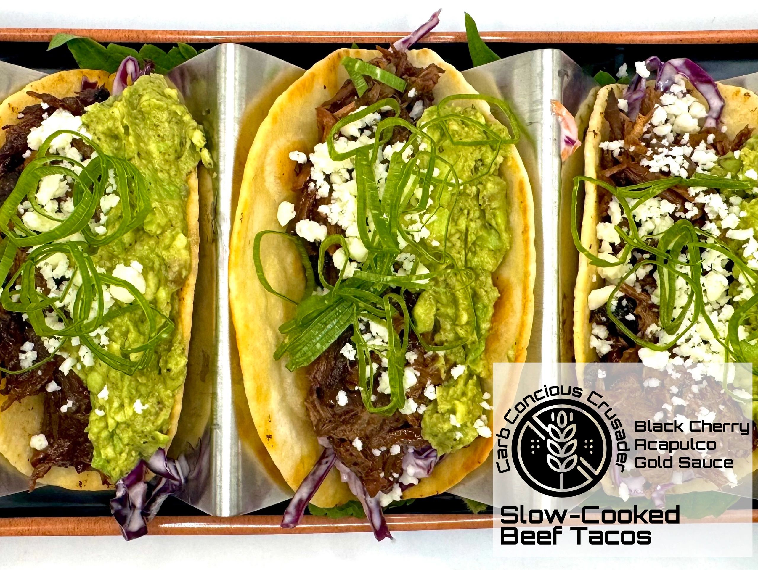 Three slow-cooked beef tacos with guacamole and cheese.