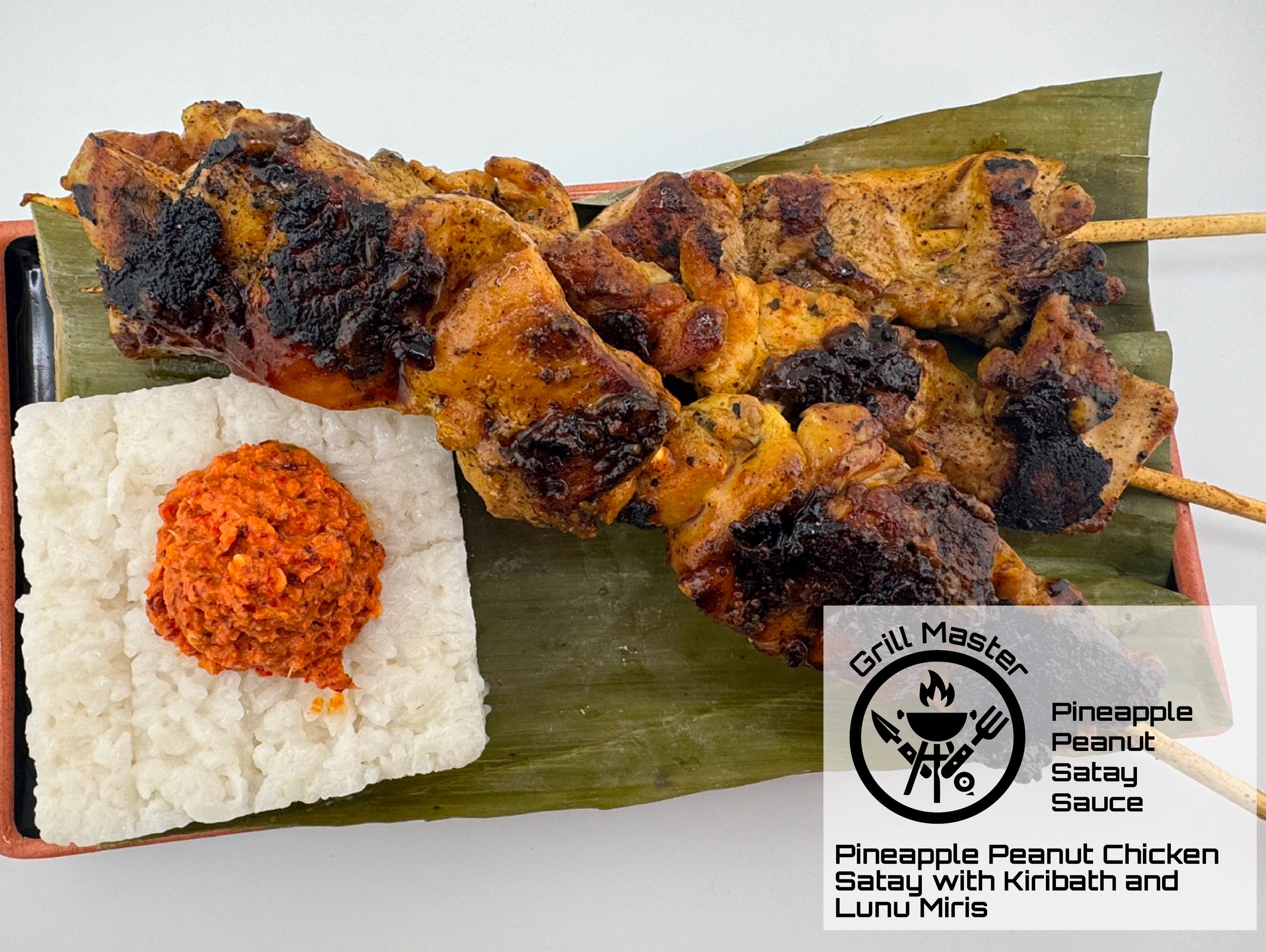 Grilled chicken satay with pineapple peanut sauce, served with kiribath and lunu miris on a banana leaf.