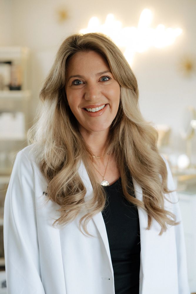 smiling nurse practioner in aesthetic clinic glowing 