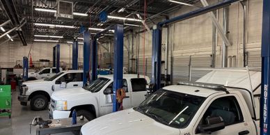 Shop full of fleet vehicles being repaired.