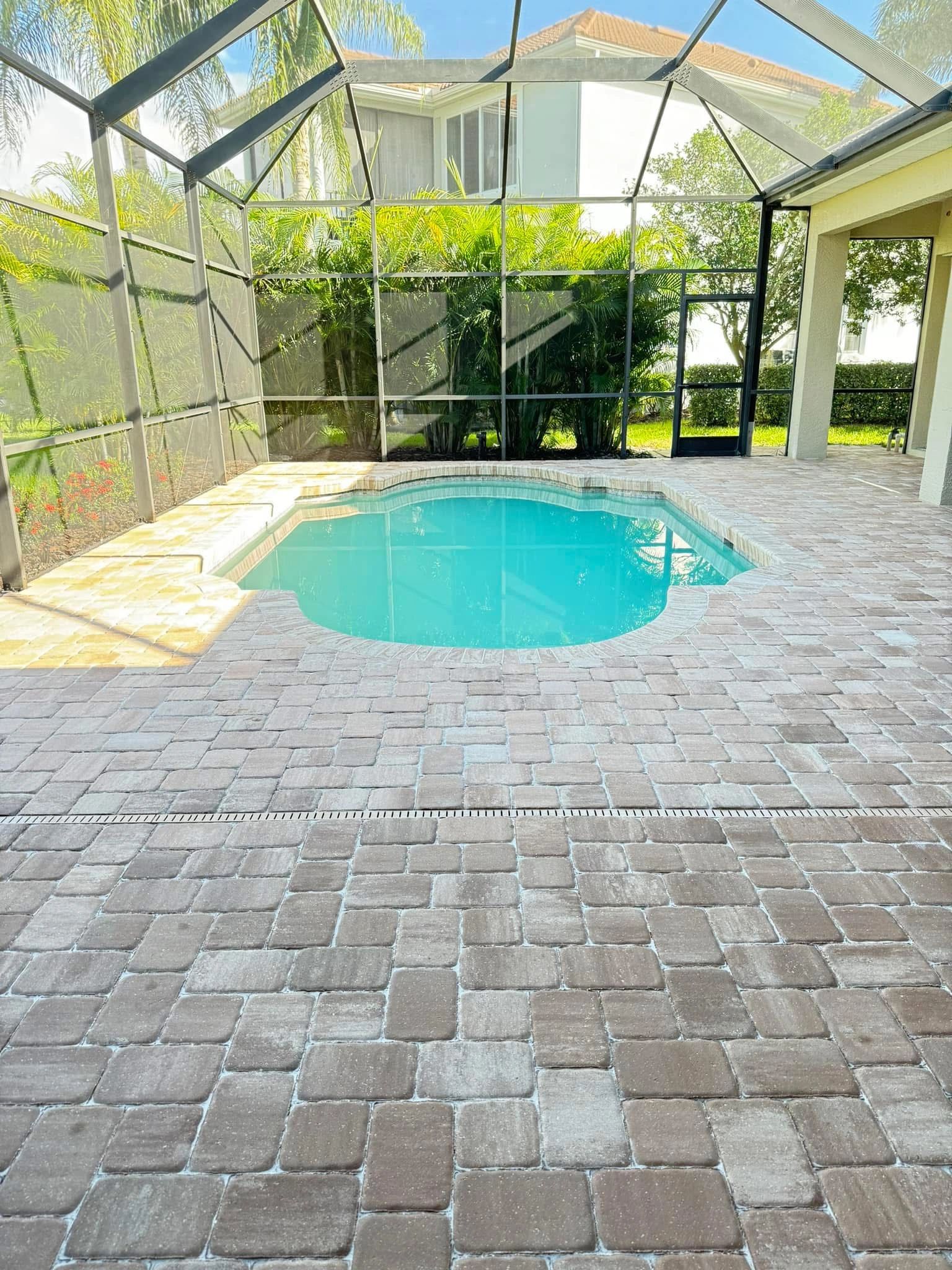 Slip-resistant pool deck pavers around a swimming pool