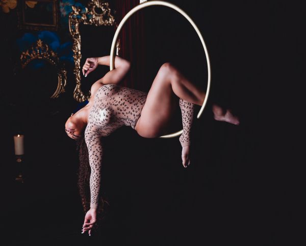Woman posing on Lyra hoop at her boudoir session.