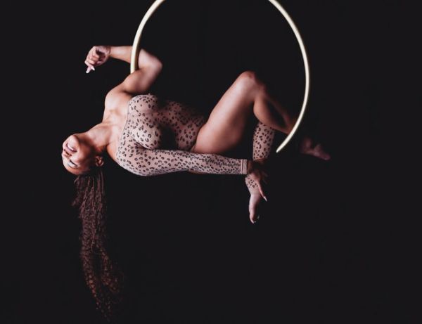 Woman posing on gold aerial hoop at her OShawa boudoir shoot.