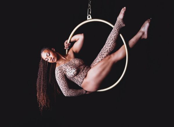 Woman posing on aerial hoop at her boudoir shoot.