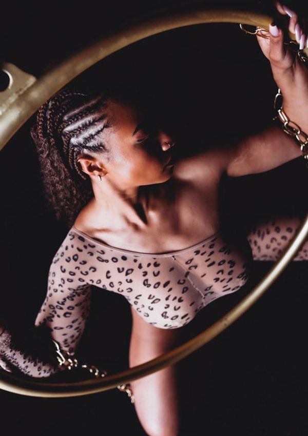 Woman posing on floor at her boudoir shoot.