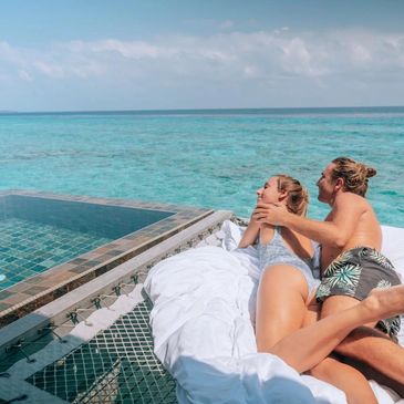 Couple relaxing by the ocean on a sunny day.