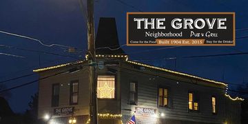 The Grove Neighborhood Pub &amp; Grill illuminated at night with festive lights.