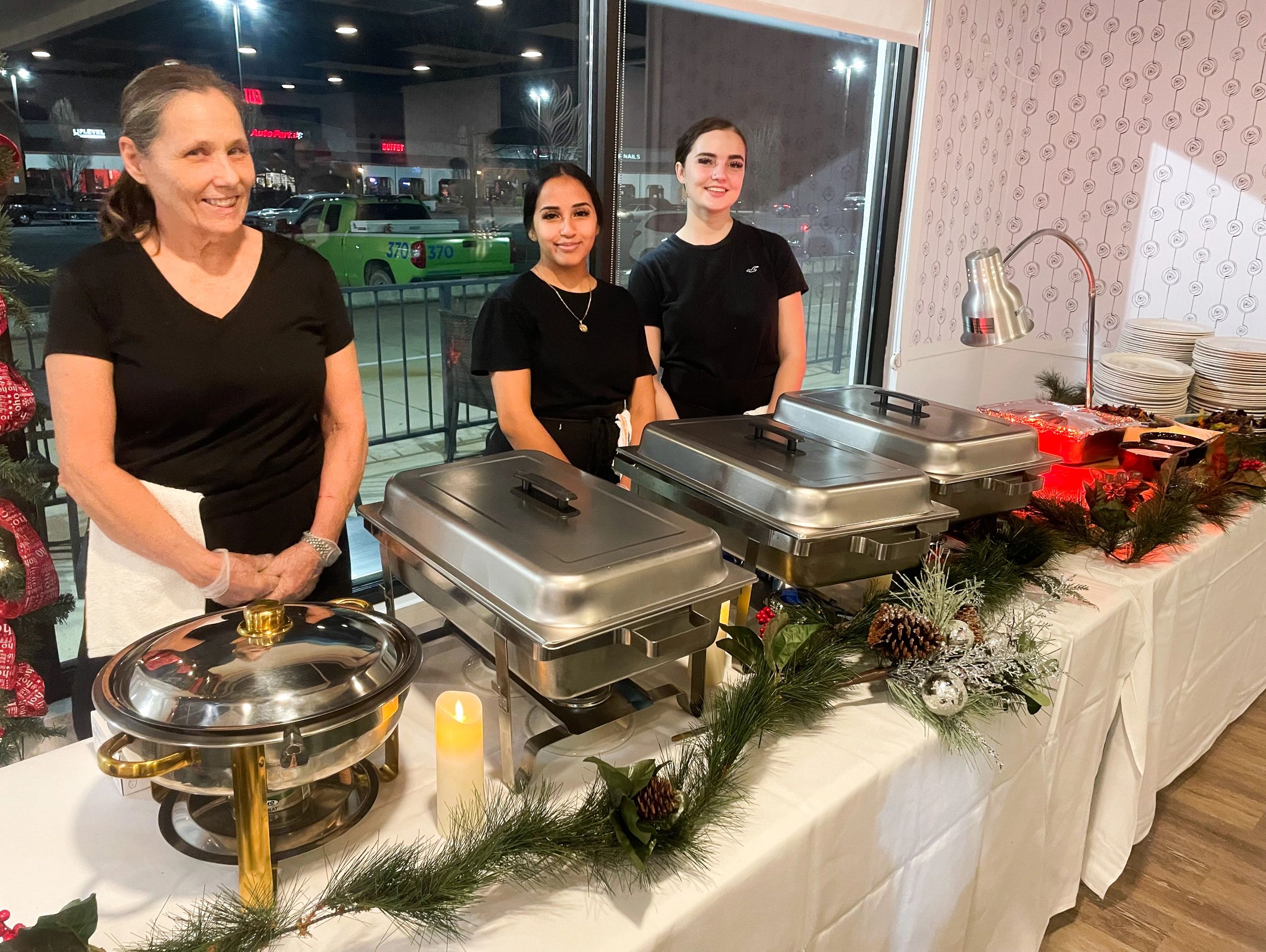Waxhaw Social Servers serving food to guests at Holiday Party. 