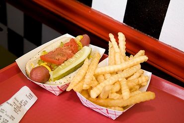 Evanston, Illinois, Chicago-style hot dog with French fries on counter of restaurant.