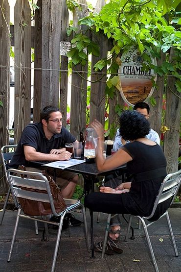 Chicago, Illinois, People seated at table of outdoor dining area of restaurant.