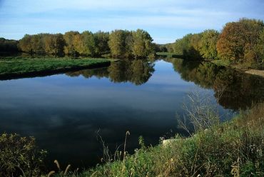 Near Lansing, Iowa, Section of Mississippi River with autumn colors on trees.