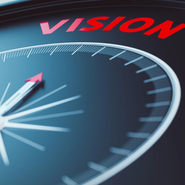 Compass pointing to a word in red letters, vision