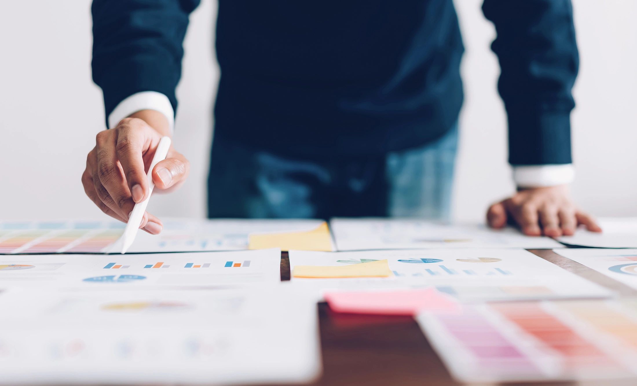 Denver HR Compliance Analysis: Man reviewing charts, pointing to key results, Katie Jipp Consulting