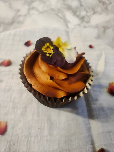 A chocolate cupcake with an edible flower
