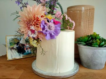 White cake decorated with fresh flowers