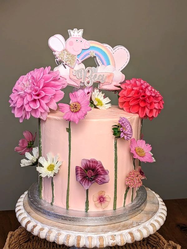 Pink cake decorated with fresh flowers 