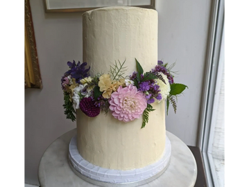 Two tier cake decorated with fresh flowers