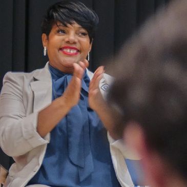 Woman clapping and smiling.