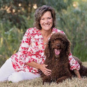 Woman smiling with brown dog