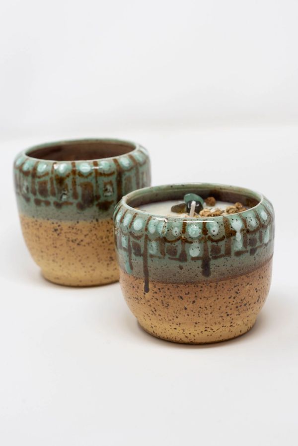Two cups with a candle inside of them.