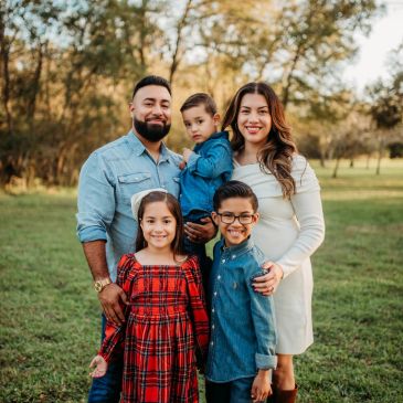 Happy family posing outdoors on a sunny day.