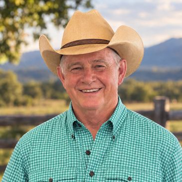 Smiling elderly man wearing a cowboy hat outdoors.