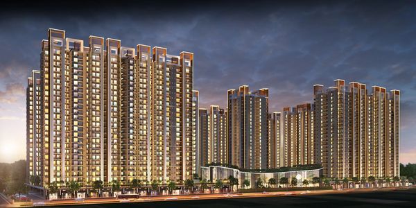 Illuminated modern apartment buildings at dusk.