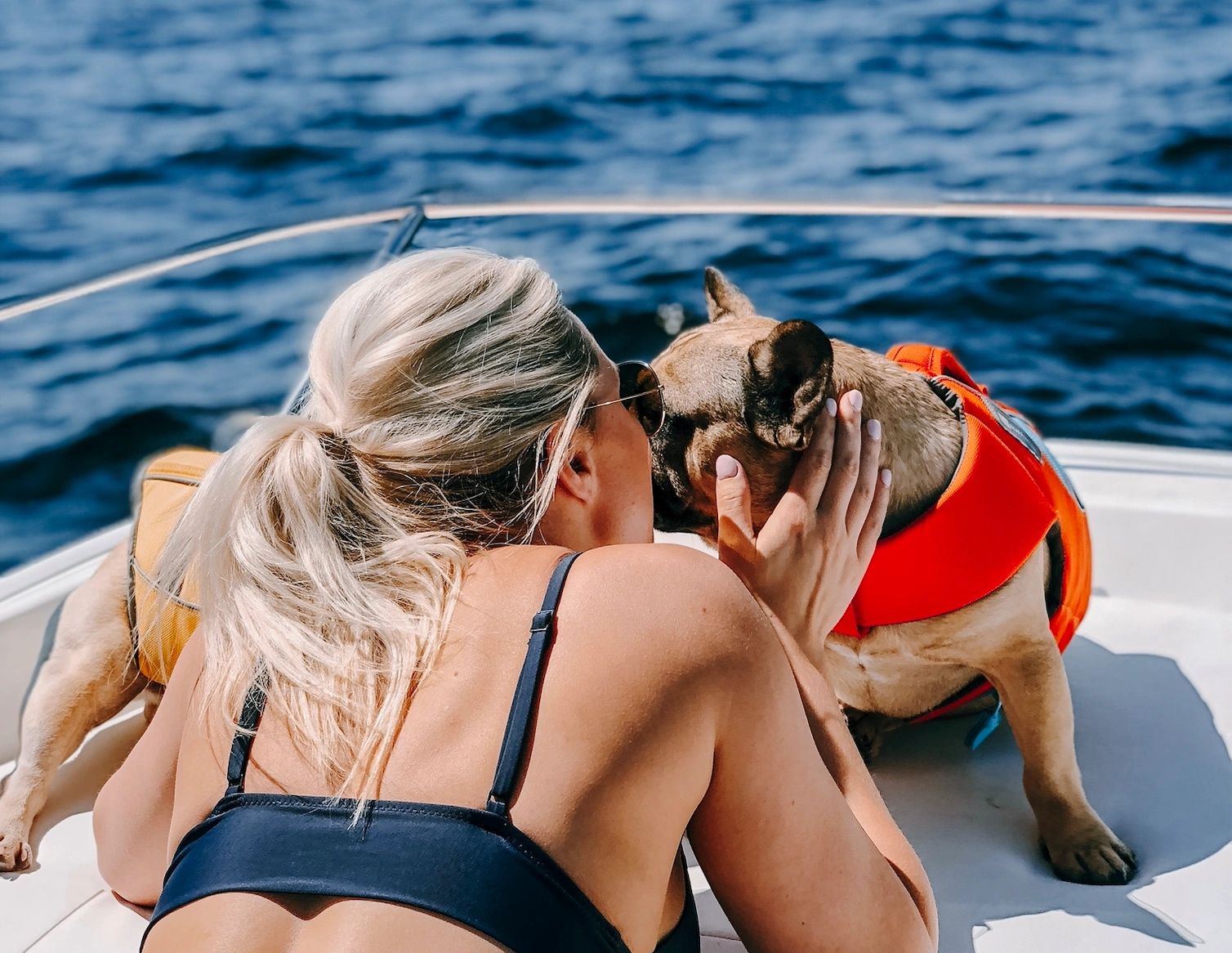 Girl with two dogs on boat