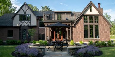 A beautiful brick house with patio furniture and garden.