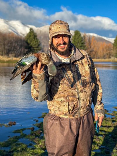 Client, Demitri Holding up his trophy, Australasian Shoveler.