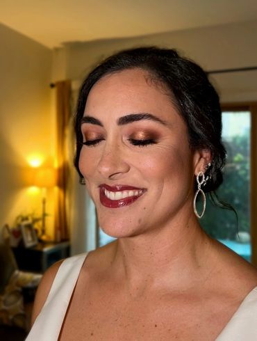 Glam bridal makeup with gold smokey halo eyes and bold lips by NYC makeup artist, Beauty by Denoise 