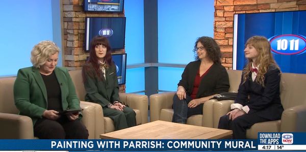 Four women in a talk show about community mural painting.