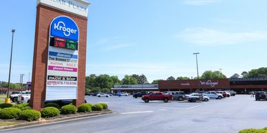 Kroger supermarket at Cedar Plaza with a spacious parking lot on a clear day.
