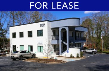 Modern two-story office building available for lease with parking spaces.