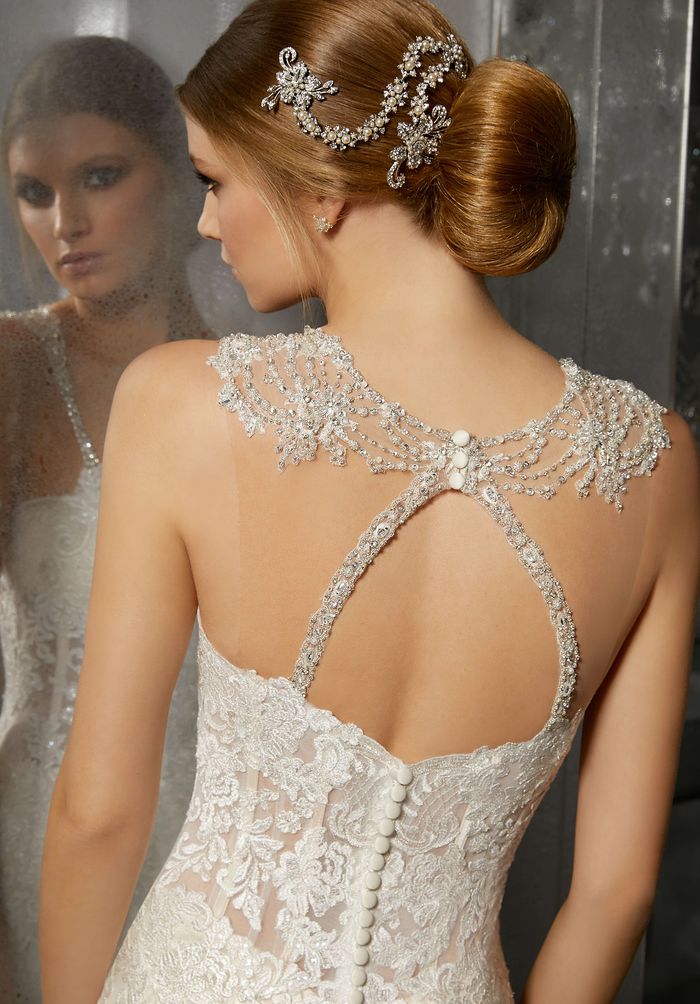 Bride in lace dress with jeweled hair accessory