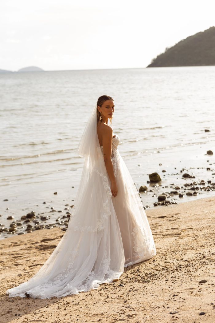 Bride in flowing veil on a beach
