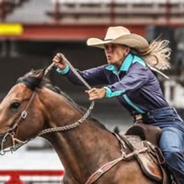 Cowgirl in action riding a horse at a rodeo.