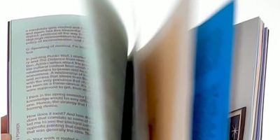 A person flipping through pages of a book.