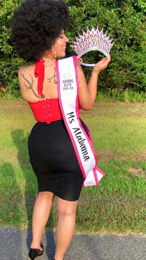 Woman holding a crown wearing Ms. Alabama sash.