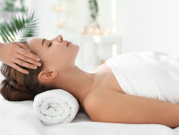 Young woman enjoying massage in spa salon
