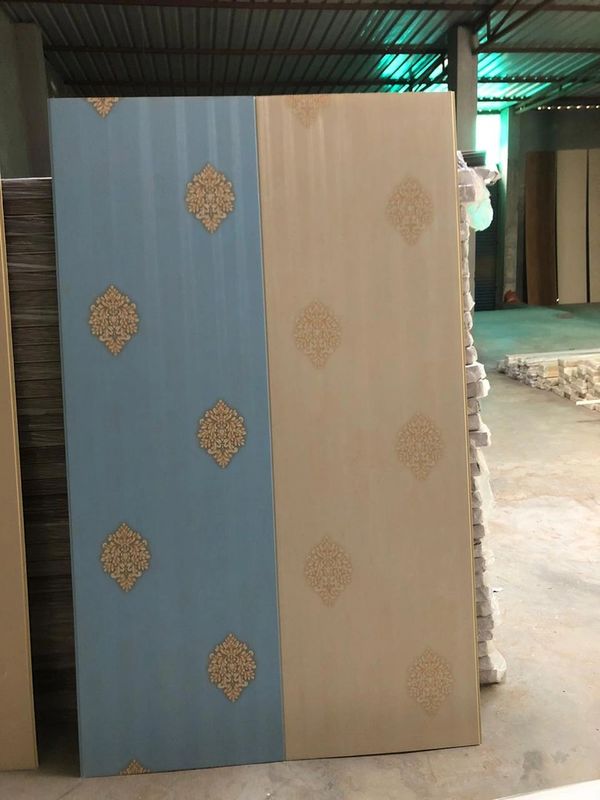 Decorative panel with blue and beige sections featuring ornate golden motifs.