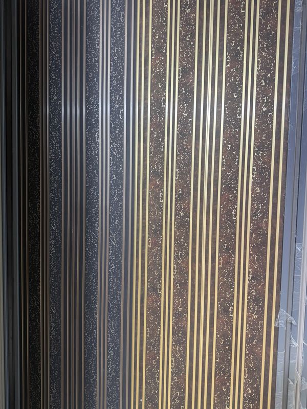 Close-up of a metallic surface with vertical striped patterns.
