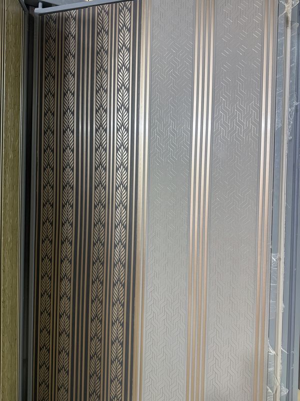 Elegant striped wallpaper with leaf and geometric patterns in gold and black tones.