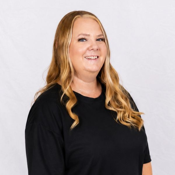 Smiling woman with long blonde hair wearing a black shirt.