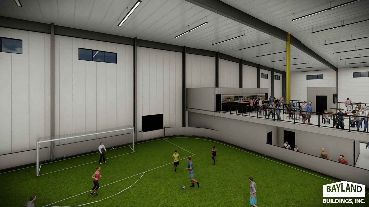 Indoor soccer field with people playing and spectators in a viewing area.