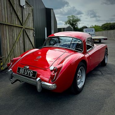 Red vintage sports car parked outdoors.