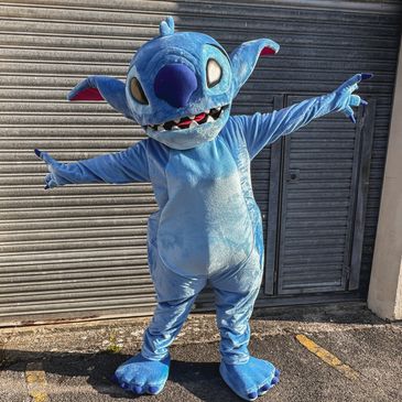 Person in a blue Stitch costume posing outdoors.